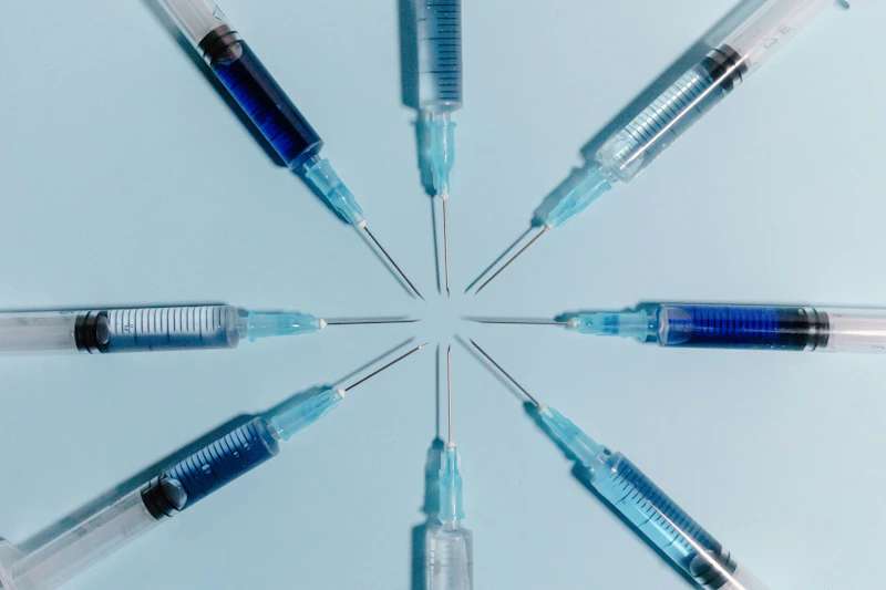 Blue syringes pointing inward